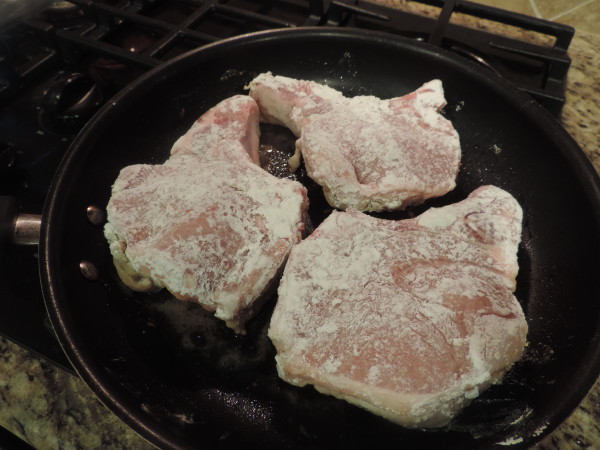 Dredged pork chops in skillet